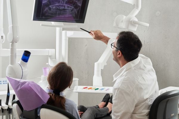 Dentist Showing Patient X-Ray